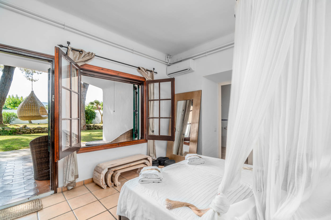 Ground floor bedroom (main house) with doors to gardens